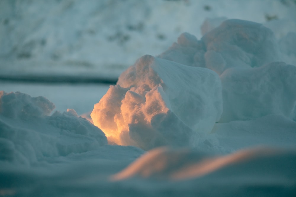 white ice on brown sand during daytime