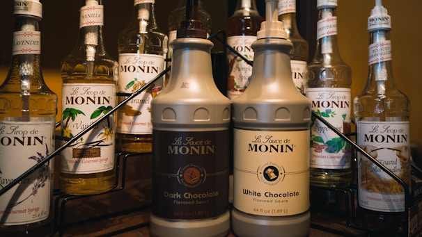 Bottles of creamy vanilla and caramel flavorings for animal feed.