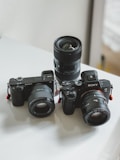 black nikon dslr camera on white table