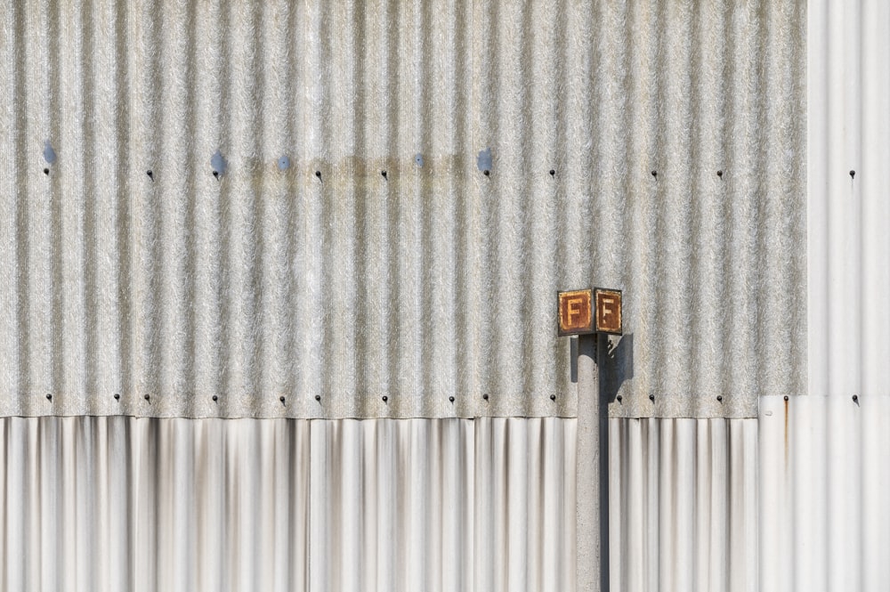 yellow and black signage on white wall