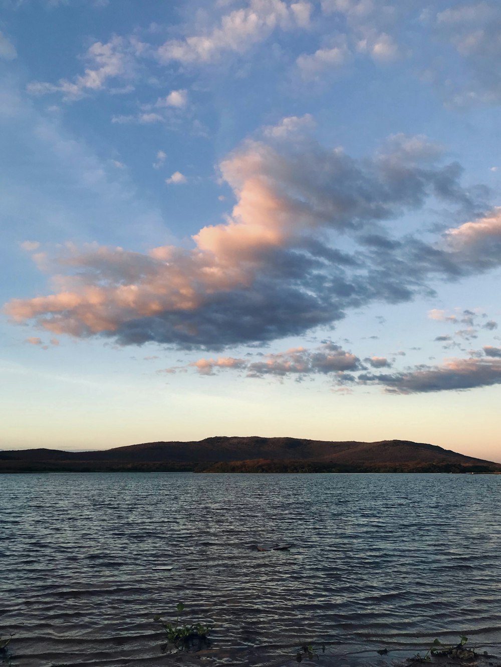 body of water under cloudy sky during daytime