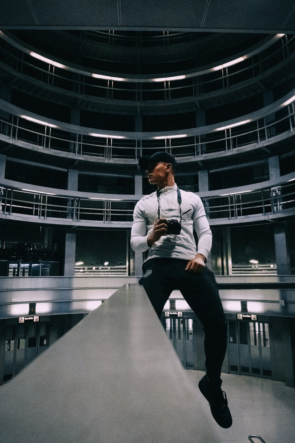 man in white dress shirt and black pants sitting on gray concrete stairs