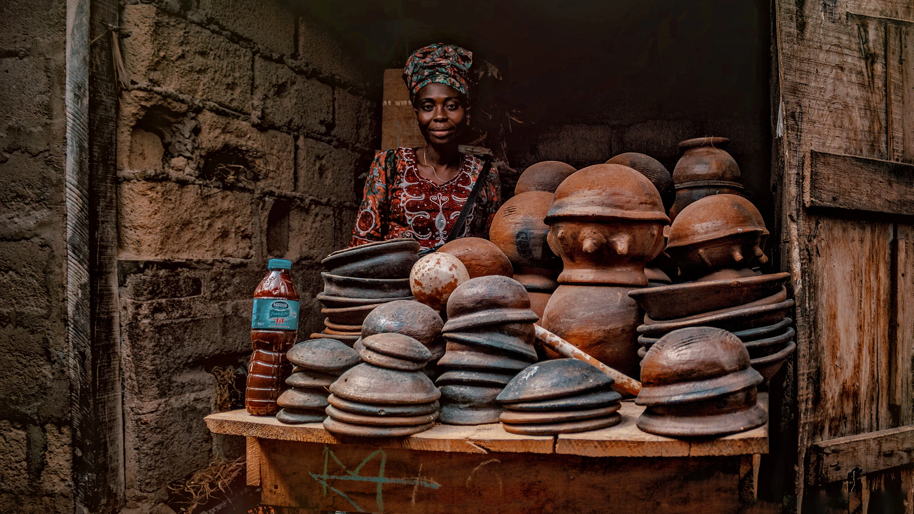 Nigerian woman presenting locally made ceramic products in Abeokuta