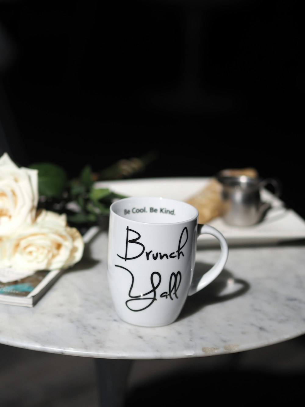 white ceramic mug on brown wooden table