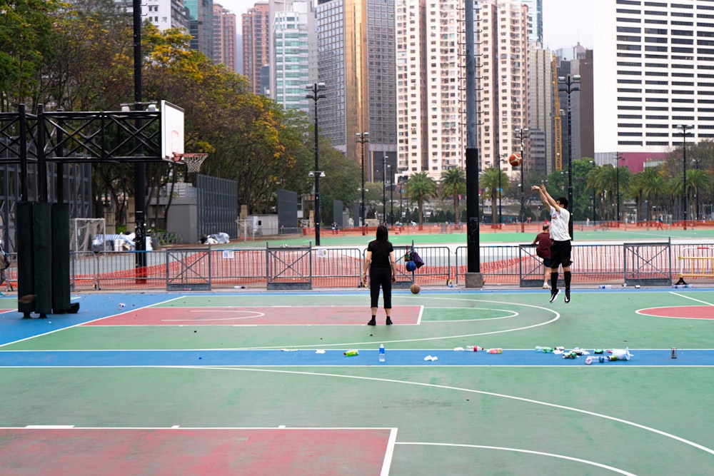 people playing basketball on basketball court during daytime