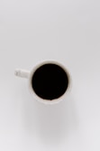 white ceramic mug with black liquid