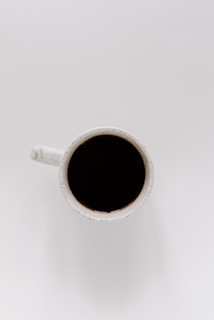white ceramic mug with black liquid