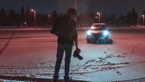 Nighttime shot showing the camera's clear detail capture and smart alarm tracking in a parking lot.