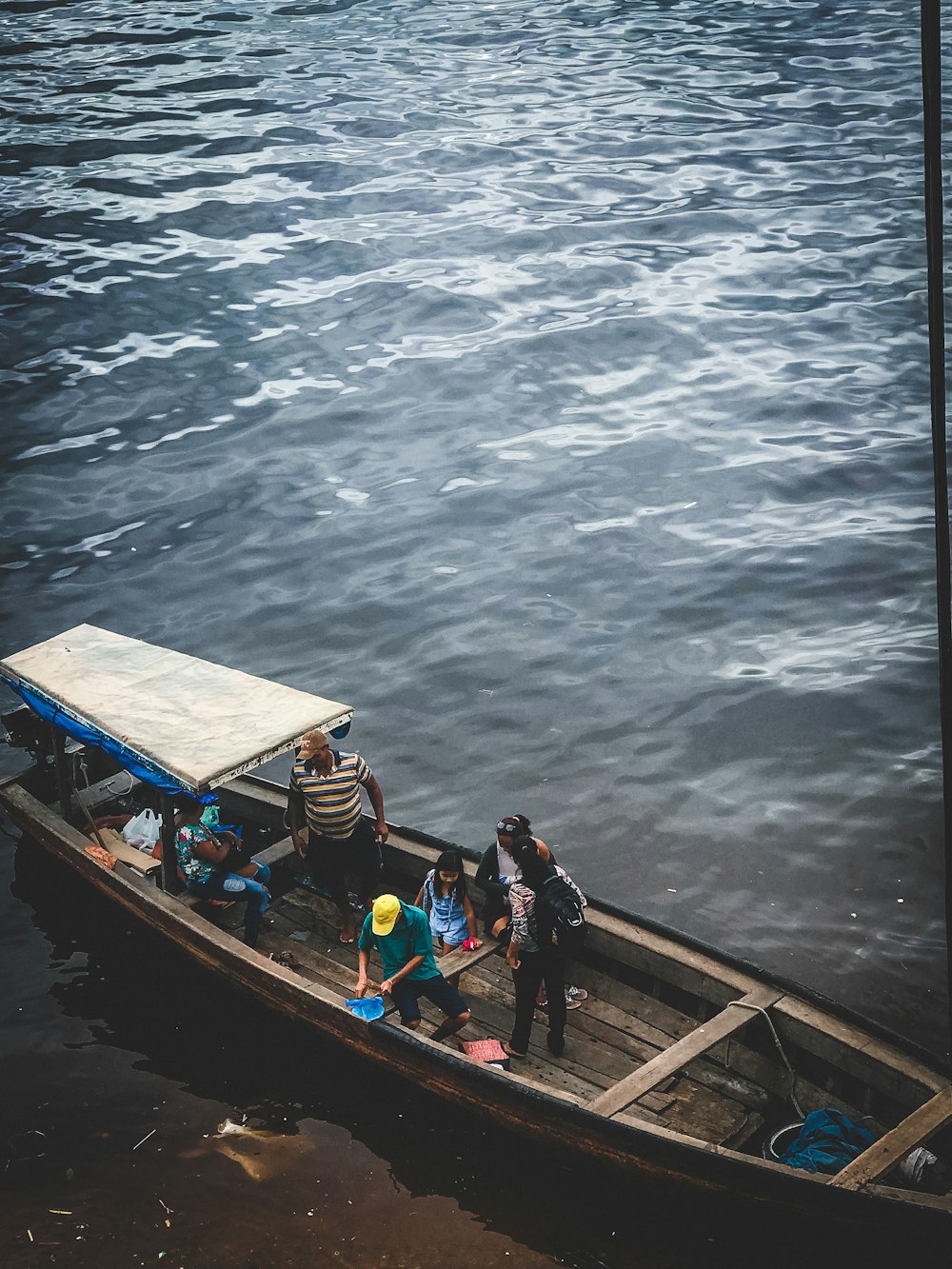people riding on blue boat during daytime