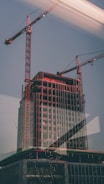 High-quality photo of a commercial building under construction with cranes.