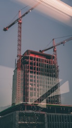 Image showing the City Tower project halfway through renovation, with cranes and construction materials visible.