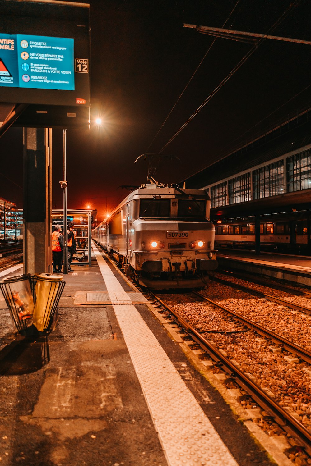 white and yellow train on rail road during night time