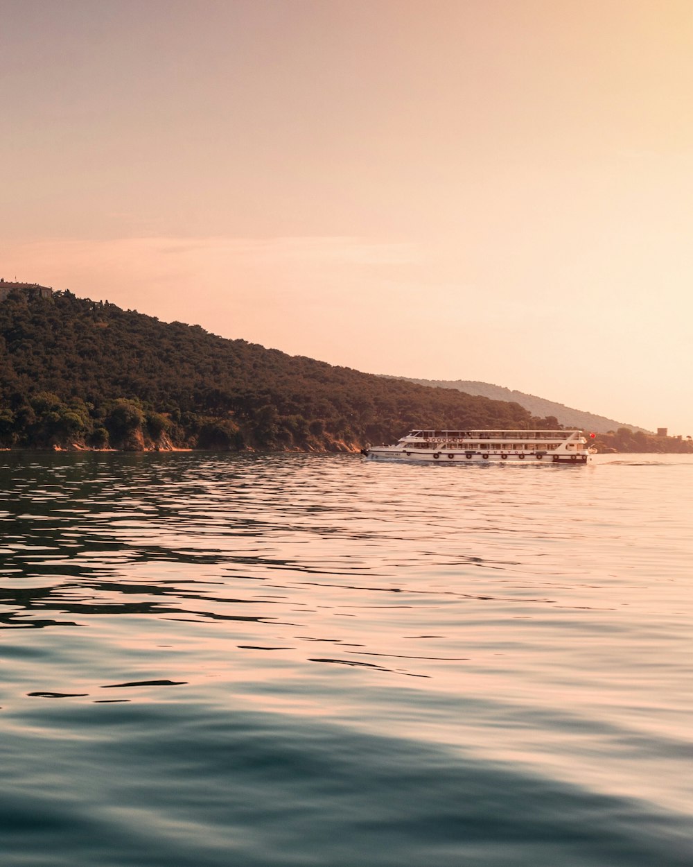 body of water near mountain during daytime