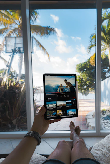 person holding black tablet computer