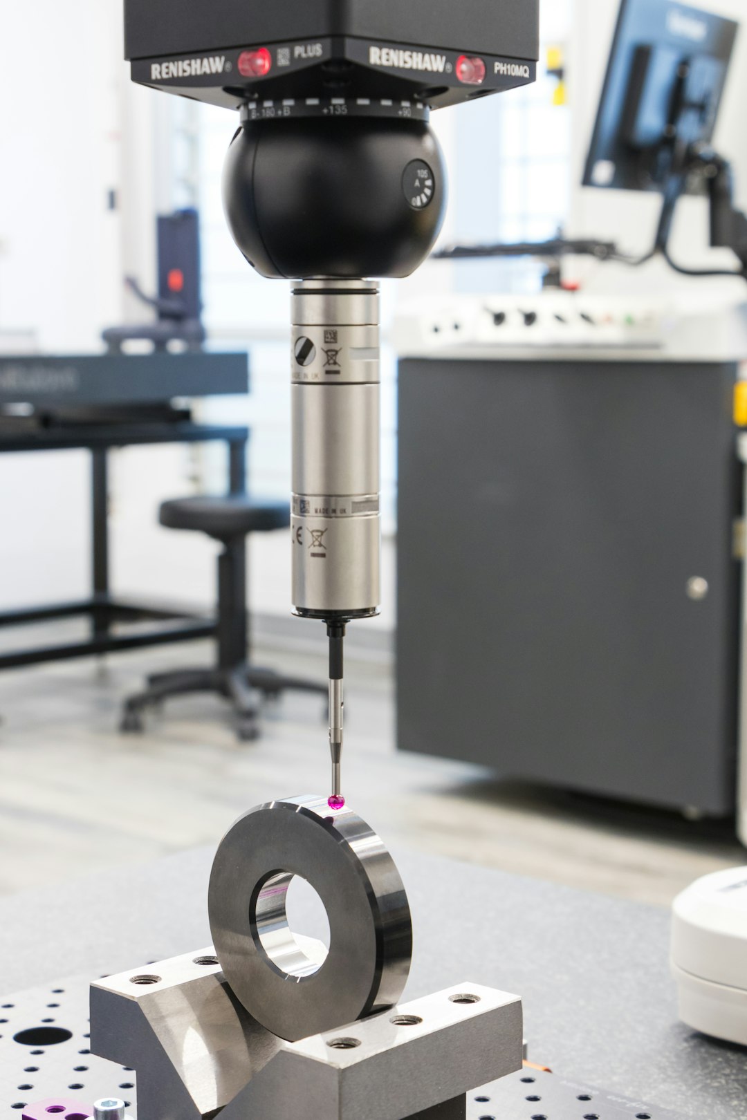 high precision inspection probe touching metal ring in clean metrology lab