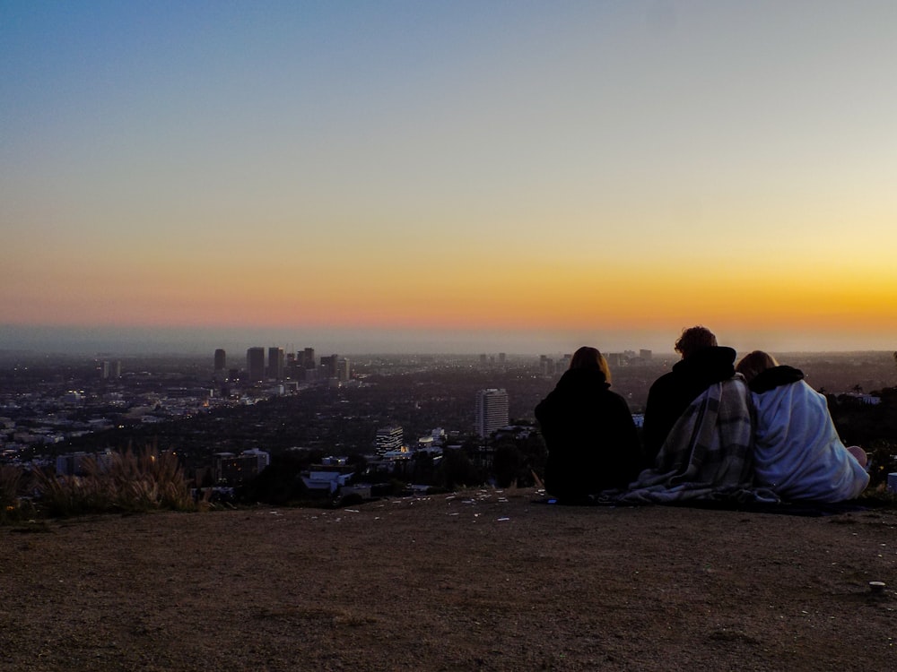 people sitting on ground during sunset