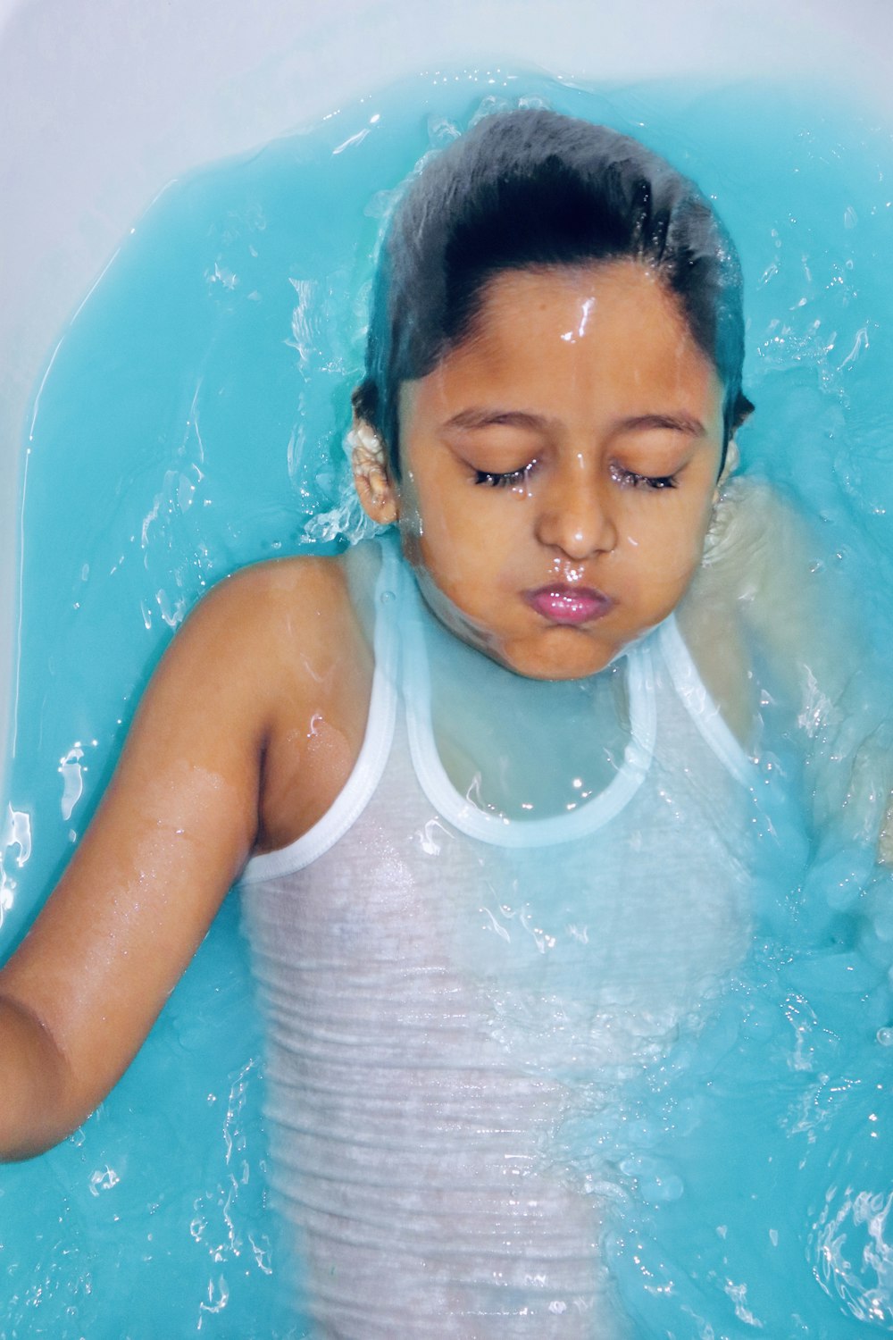 girl in white tank top in swimming pool