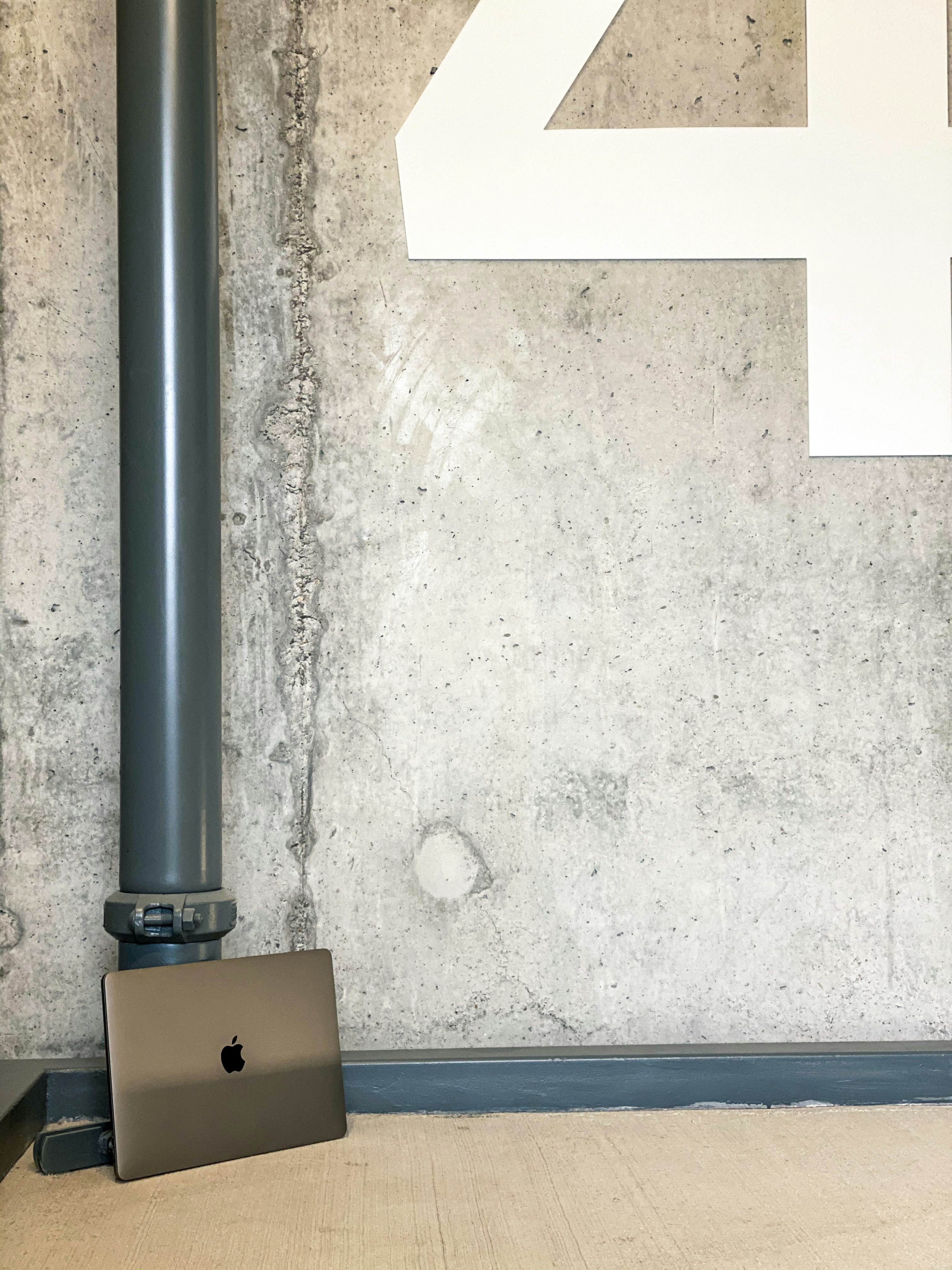 black metal pipe on white wall