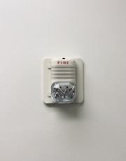 white and black electric device mounted on white wall