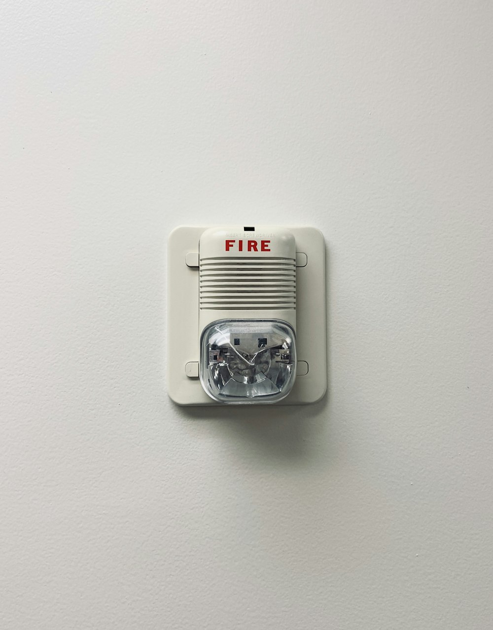 white and black electric device mounted on white wall