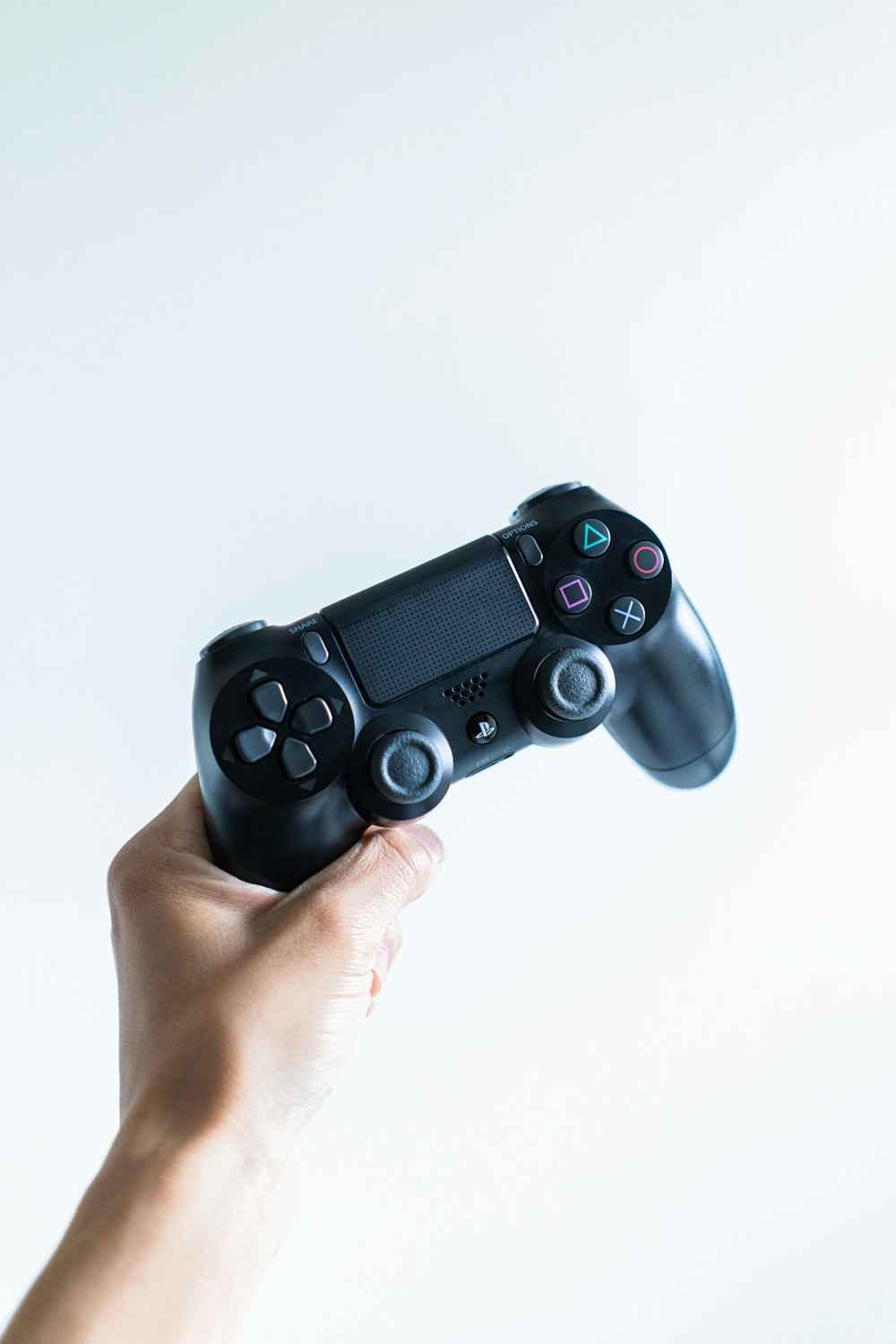 person holding black sony ps 4 game controller