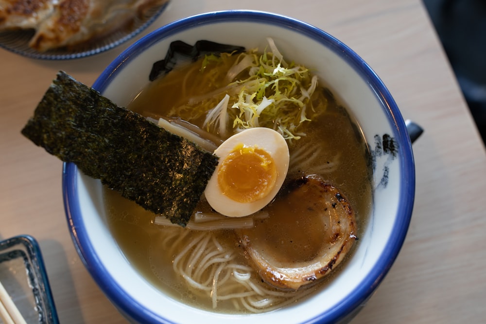 soup with egg on blue ceramic bowl