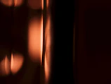 Art piece featuring abstract light patterns in warm tones.
