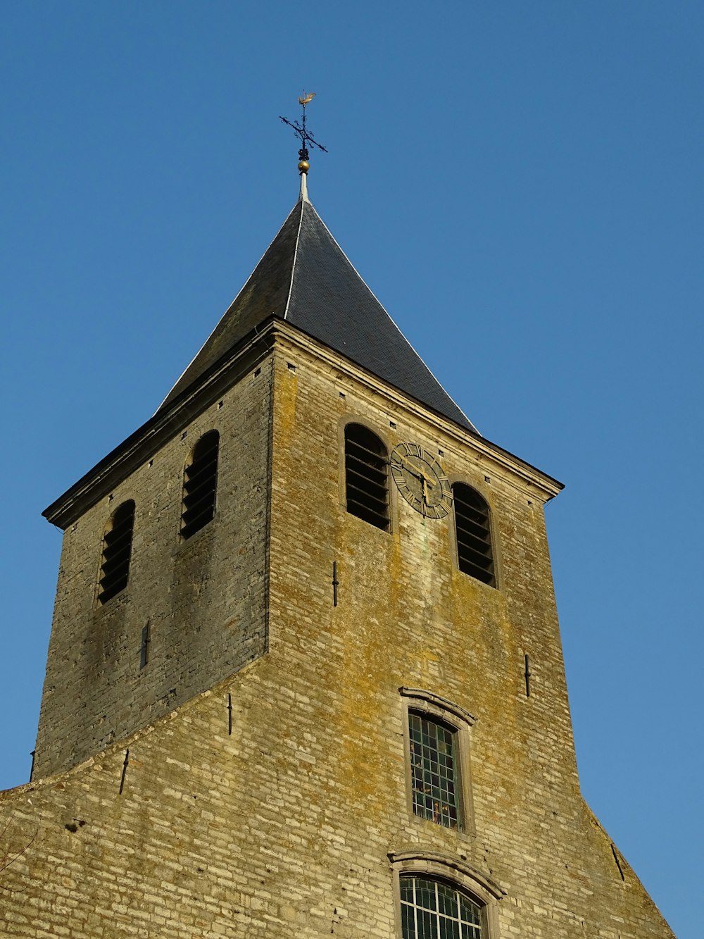 brown brick building under blue sky during daytime