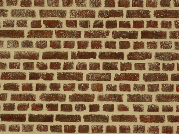 A pattern of evenly spaced reddish-brown bricks arranged with mortar, creating a textured and uniform appearance.