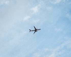 An airplane taking off against a clear blue sky, symbolizing travel and movement.