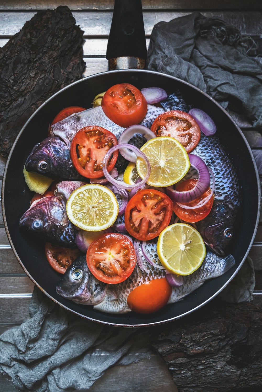 sliced orange fruit on black round plate