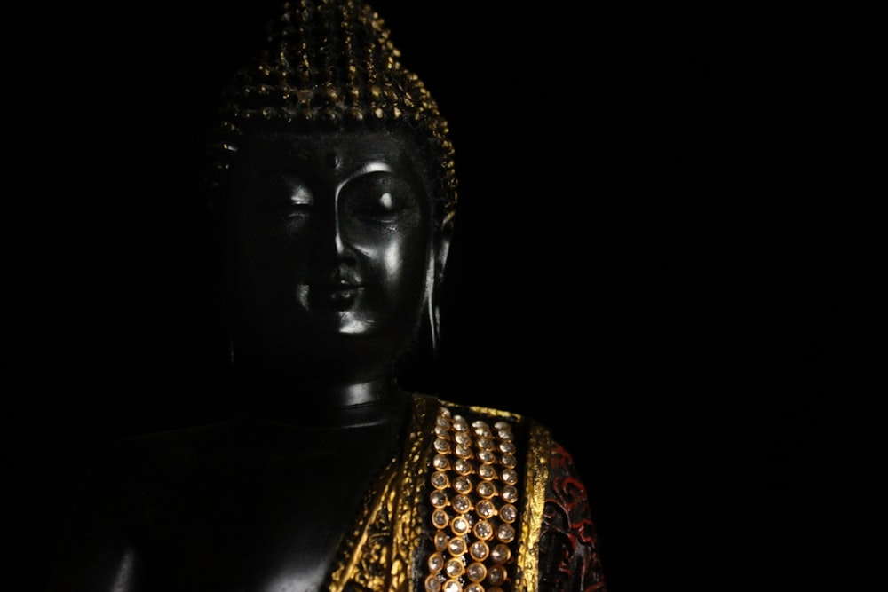 black and gold buddha statue