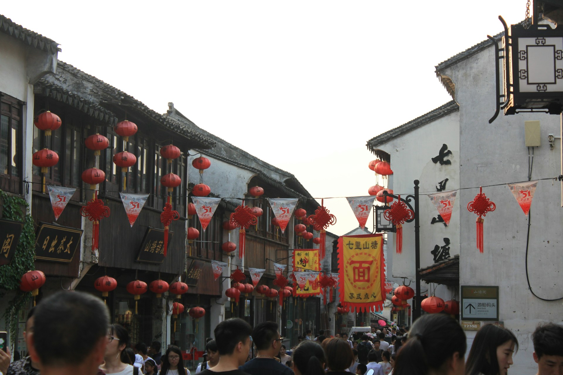 woman wearing yellow long-sleeved dress under white clouds and blue sky during daytime