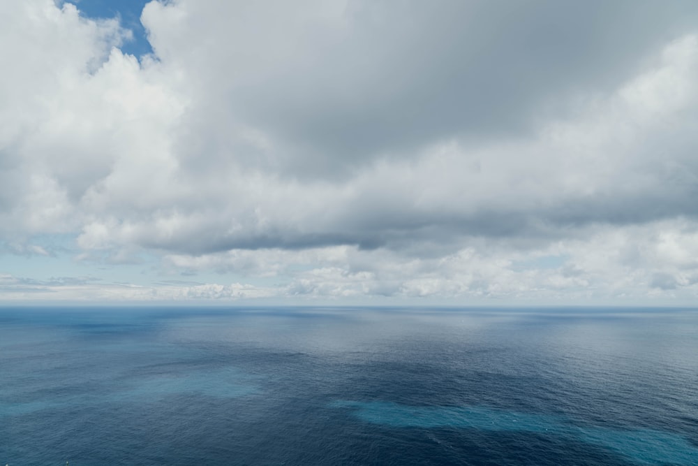 blue sea under white clouds during daytime