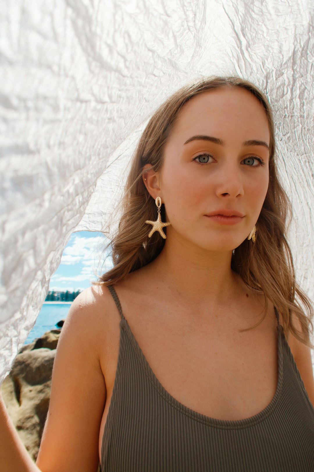 woman in black tank top wearing white earbuds