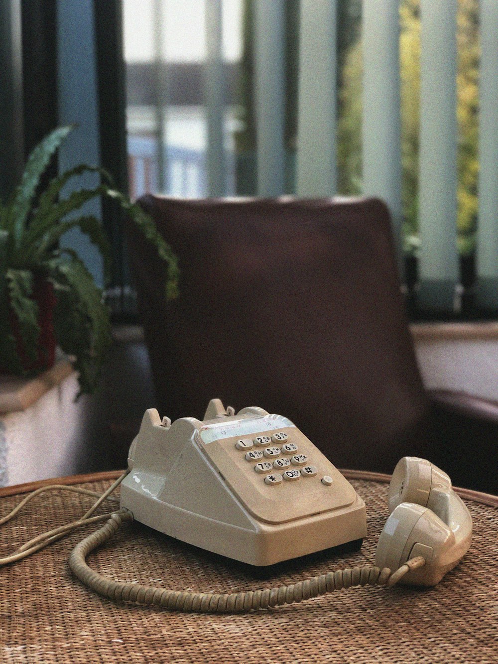 white and gray ip desk phone on brown wooden table