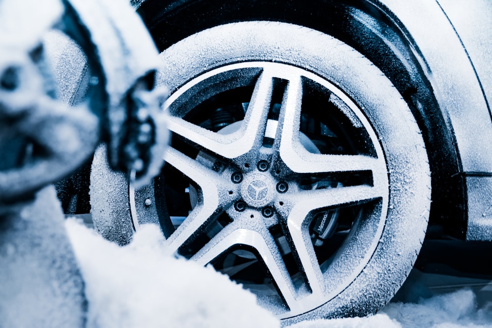 black mercedes benz wheel with snow