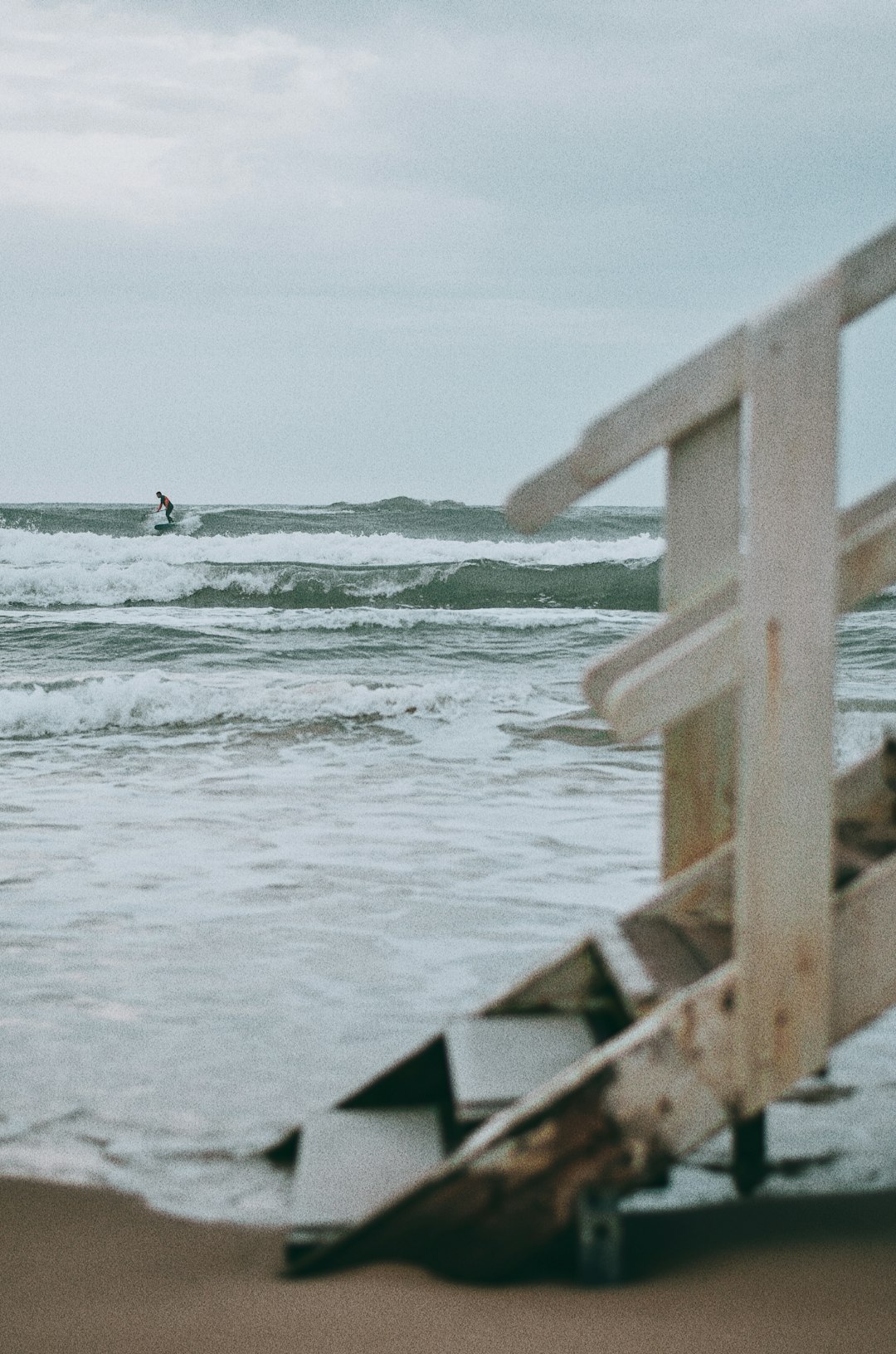 person surfing on sea waves during daytime