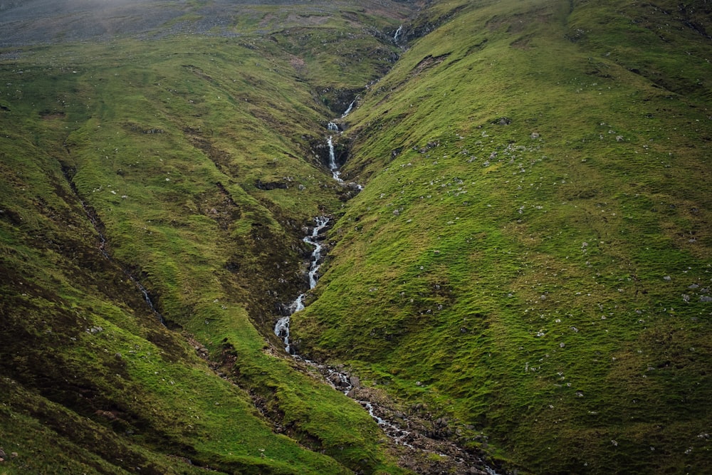 green grass covered mountain during daytime