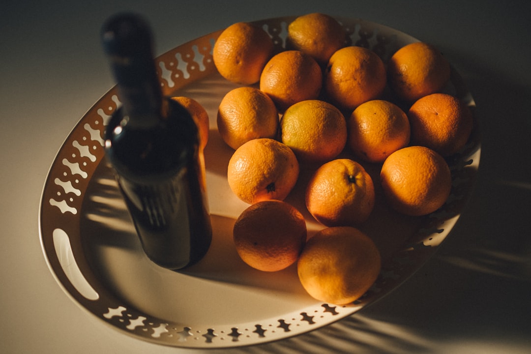 orange fruits on white ceramic plate