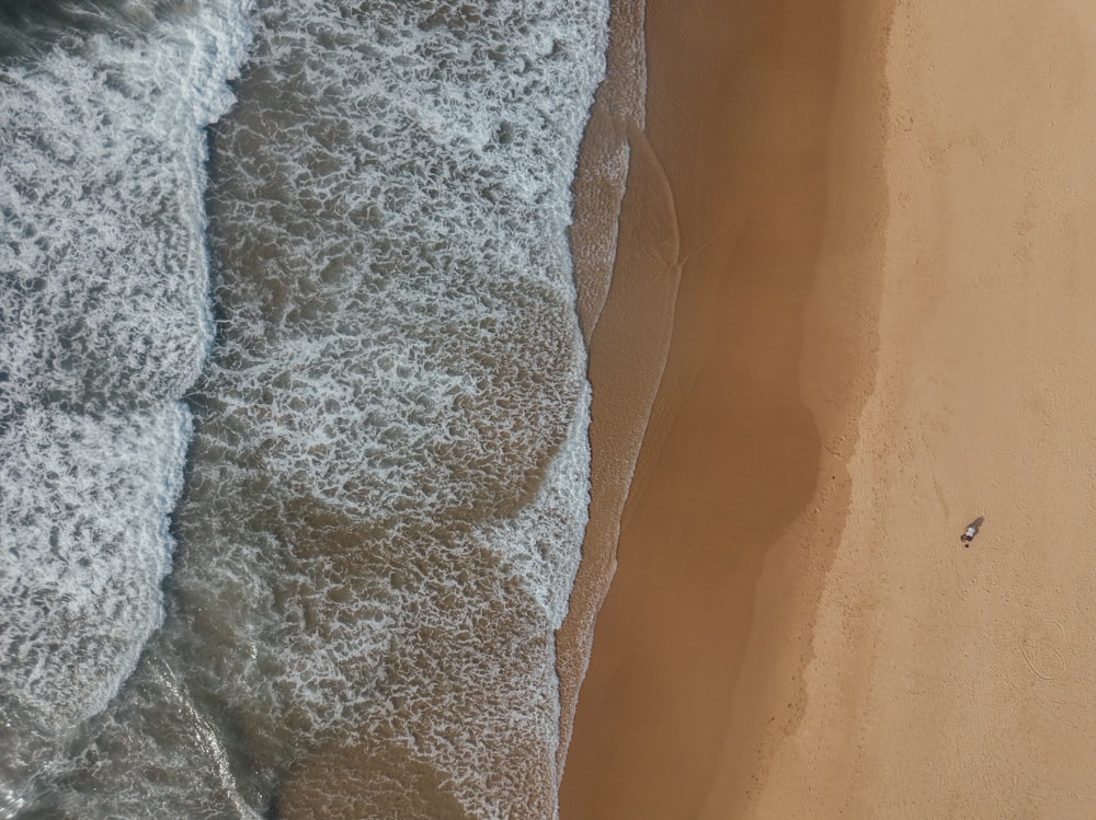 white and gray textile on brown sand