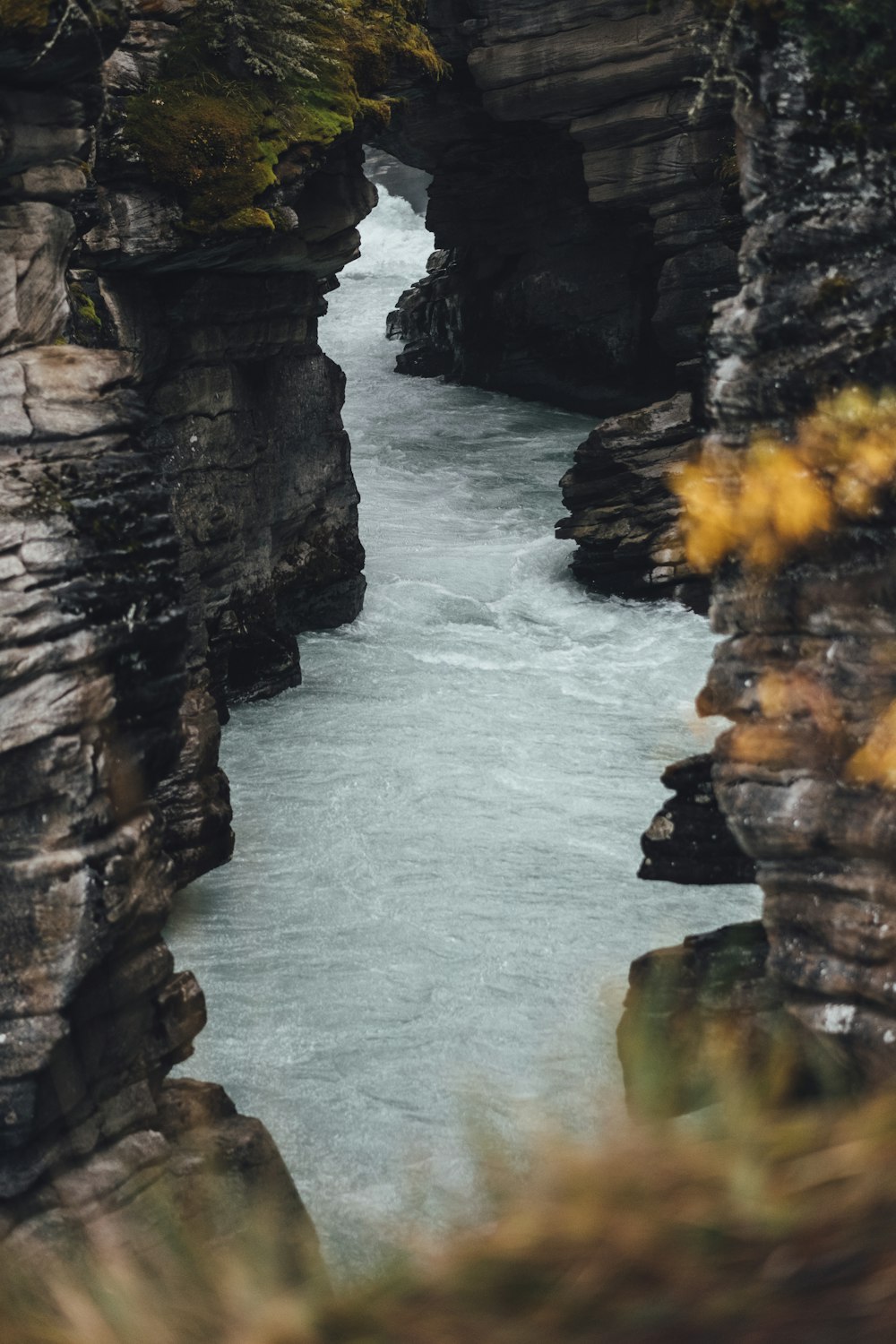 brown rock formation beside body of water during daytime