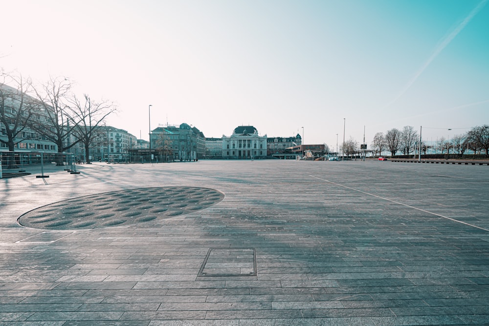 gray concrete road with cars parked on the side during daytime