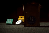 Soap bars and detergent capsules side by side with reflections on a glossy surface