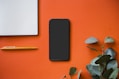 black iphone 5 on orange surface
