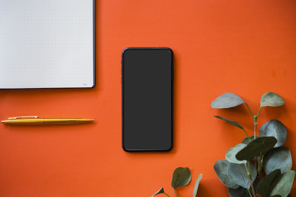black iphone 5 on orange surface