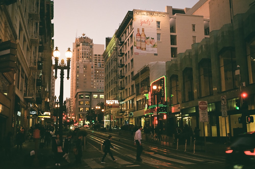 people walking on street near buildings during night time