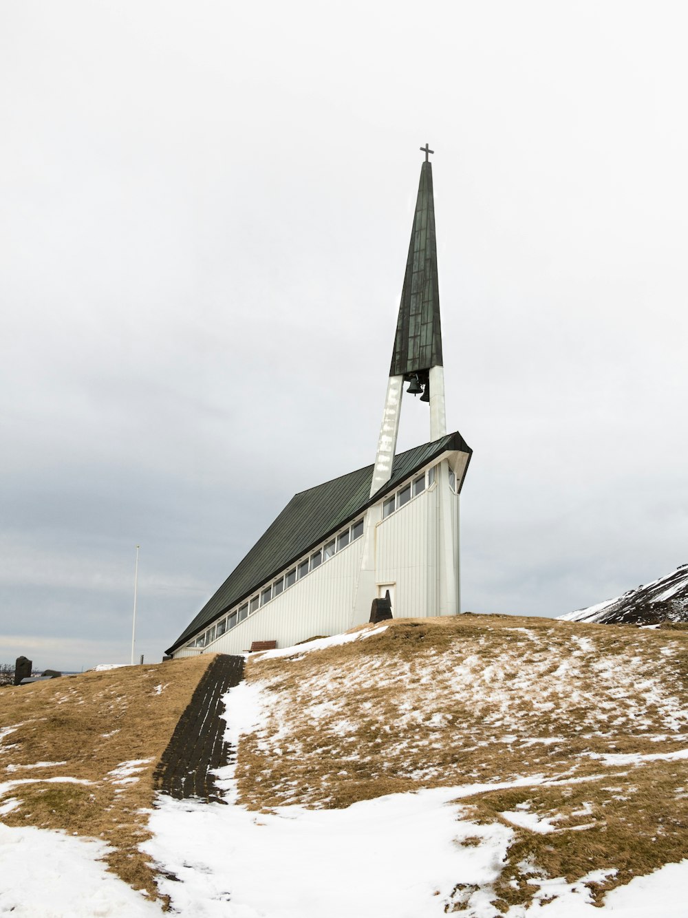 white and green church under cloudy sky during daytime