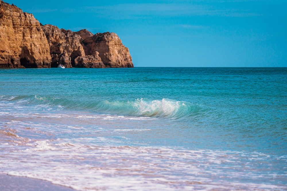 brown rock formation on sea during daytime