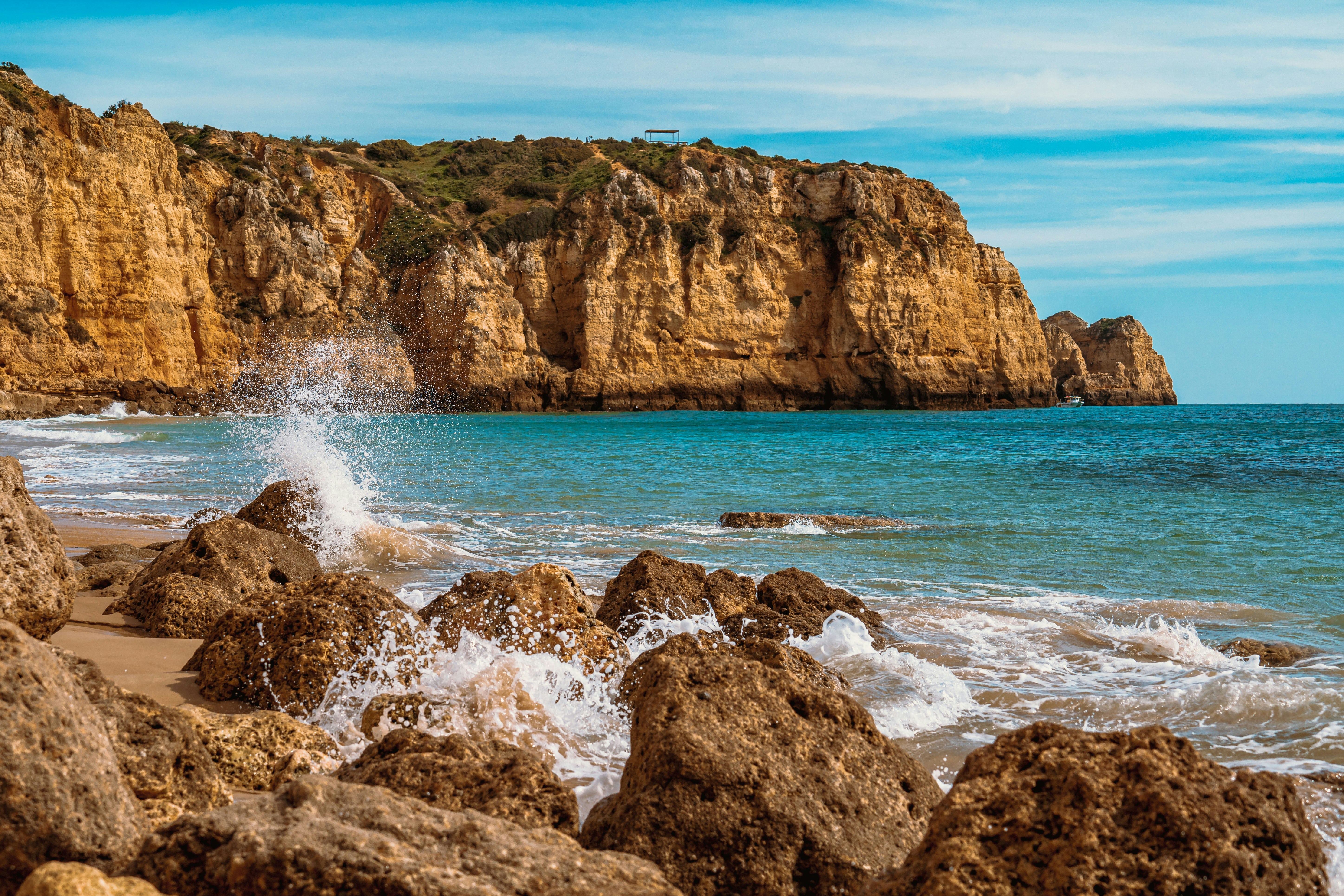 brown rock formation on sea during daytime